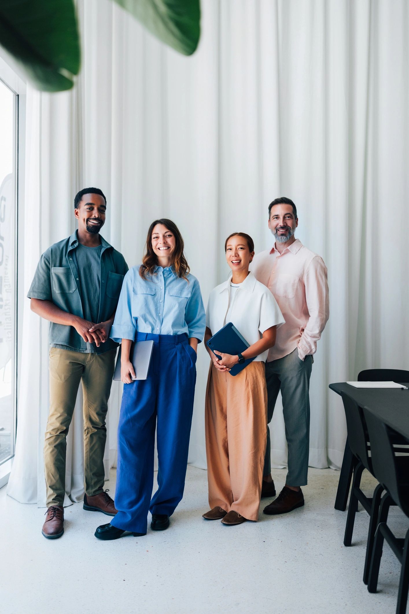 Professional insurance team standing together in a modern office