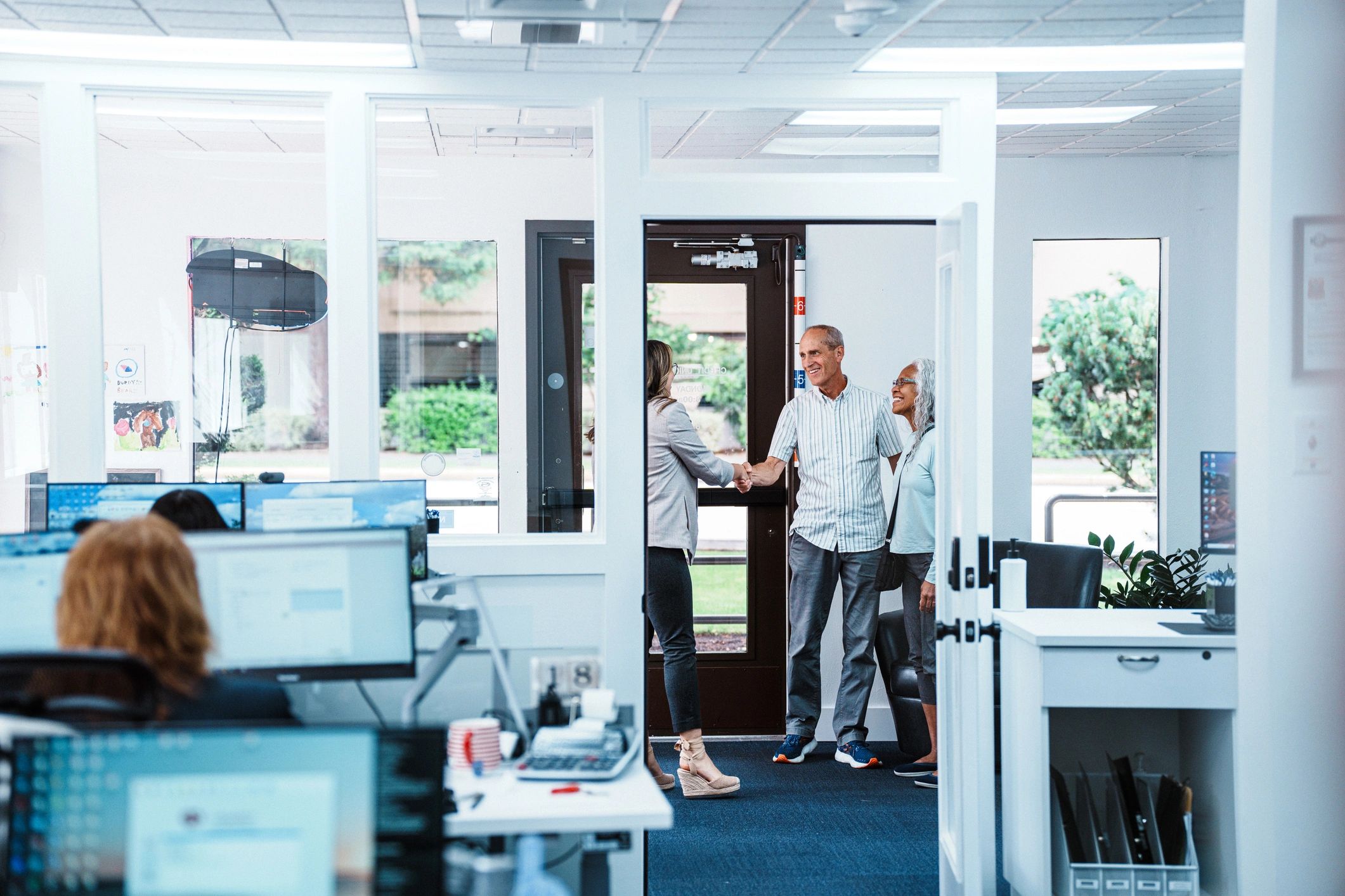 Advisor greeting clients before an insurance consultation